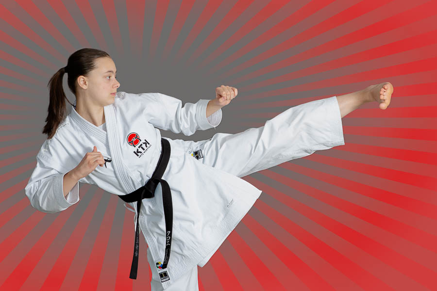 Sports photography of a sensei at KTK martial arts performing a side kick during a demonstration in Ottawa