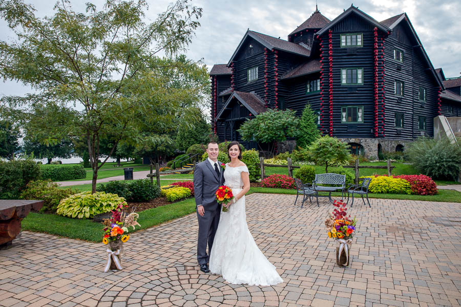 A bride and groom pose for a wedding portrait outside the gardens of Fairmont Château Montebello in Ottawa.
