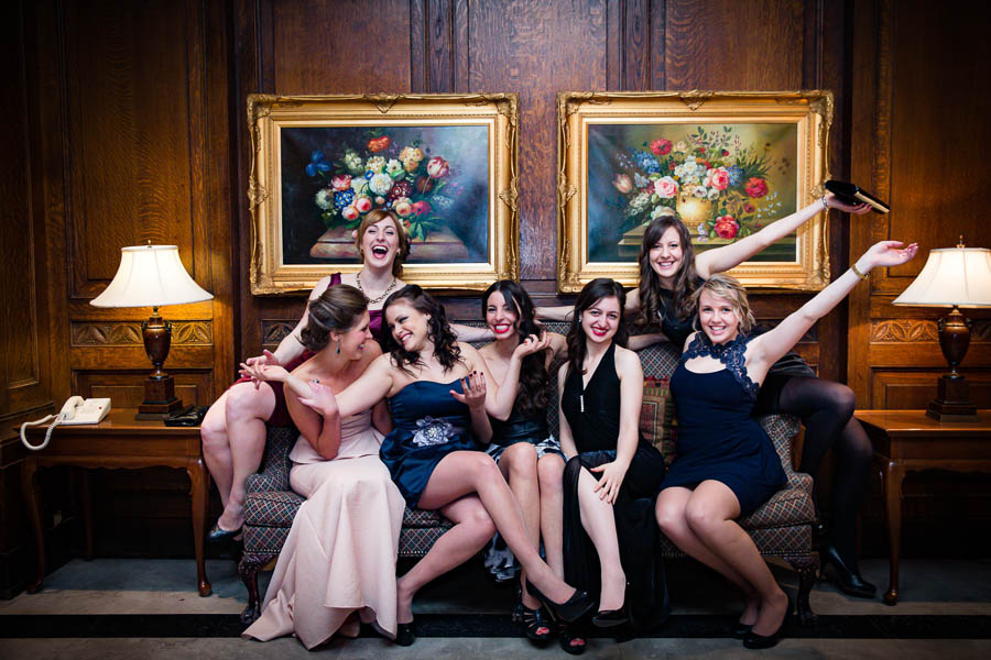 Seven Carleton University students from the School of Public Policy and Administration (SPPA) pose on a couch at the Fairmont Château Laurier in Ottawa during a gala.