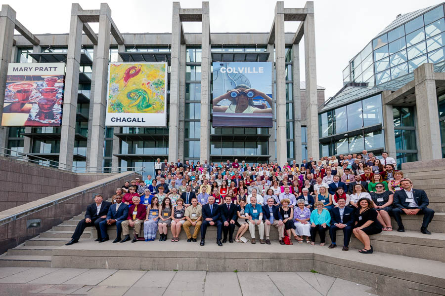 A group photo of 300 plus alumni of Mount Allison University pose on the outdoor steps of the National Art Gallery to celebrate Canadian Artists, Pratt, Chagall, and Colville.