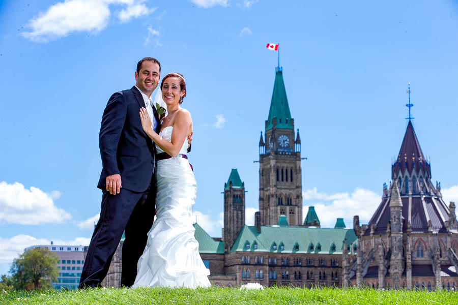 Caroline and Andrew pose for a wedding portrait with Parliament Hill in the background.