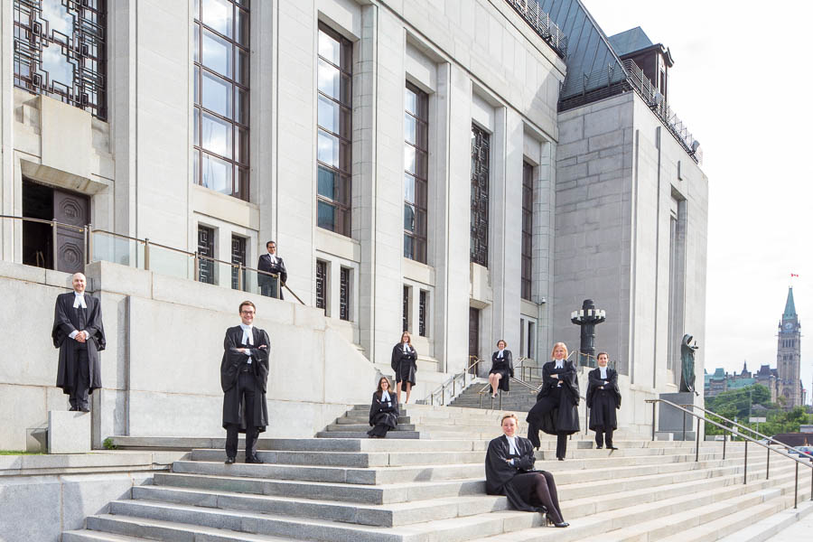 Emilie and her classmates pose for their graduation photo on the steps of the Supreme Court of Canada.
