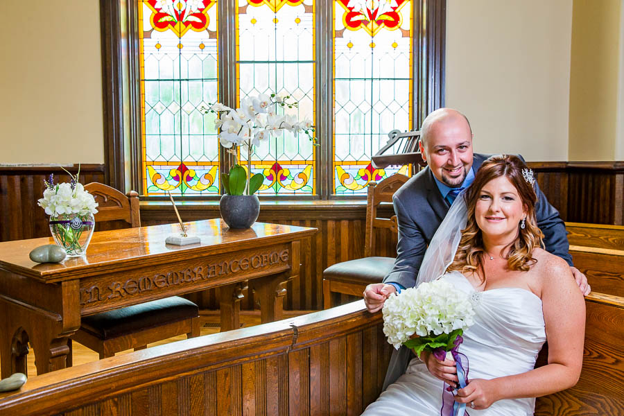 Tammy and Mitch pose for an indoor wedding portrait at the Knox in Merrickville-Wolford, Ontario.